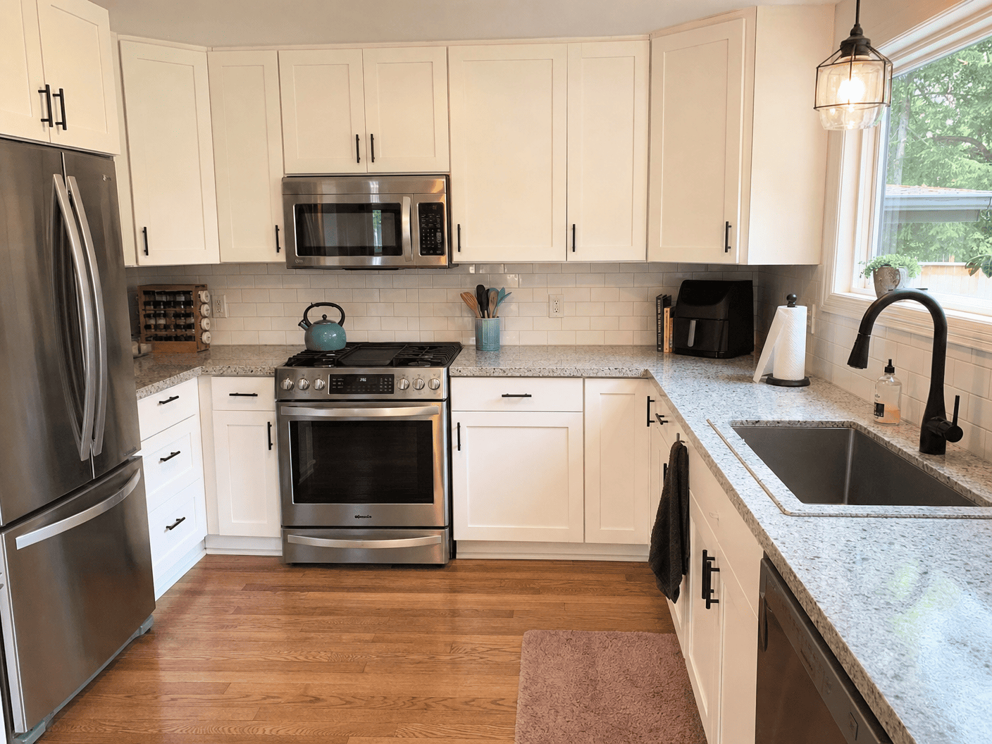 Spotless white kitchen with granite countertops
