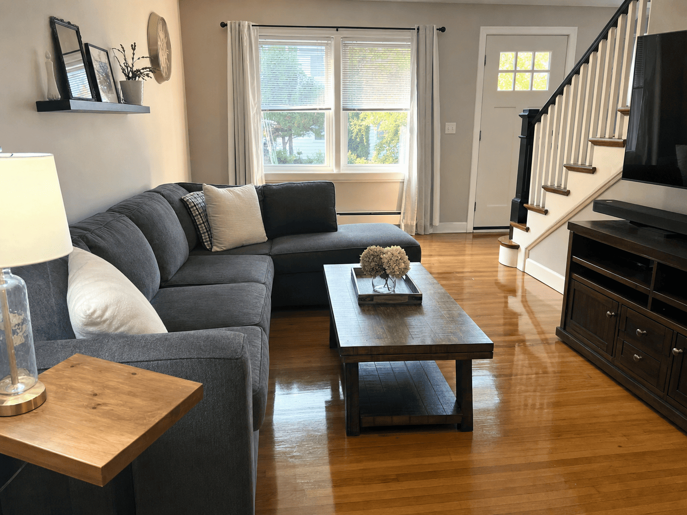 Bright living room with sectional sofa and hardwood floors